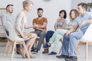 Adult people participating in group psychotherapy session
